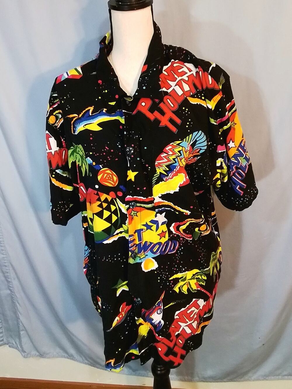 Planet Hollywood ; Colorful shirt; Black background